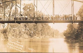 The lynching of Laura Nelson and her son, several dozen onlookers. May 25, 1911, Okemah, Oklahoma.Gelatin silver print. Real photo postcard. 5 1/2 x 3 1/2"